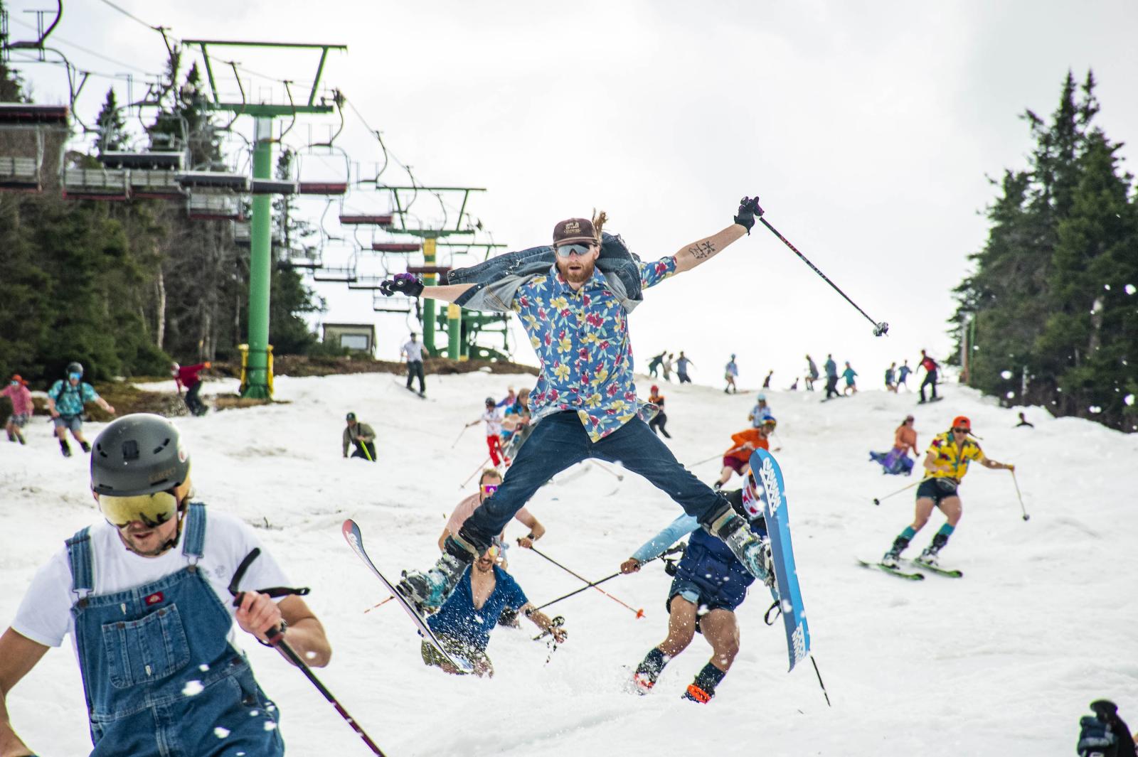 Skier jumping with group