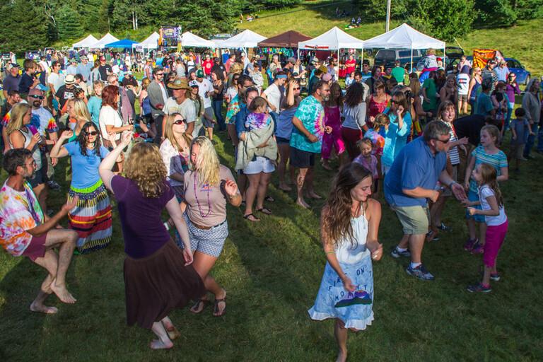 Colorful people dancing to Grateful Dead's Sugar Magnolia
