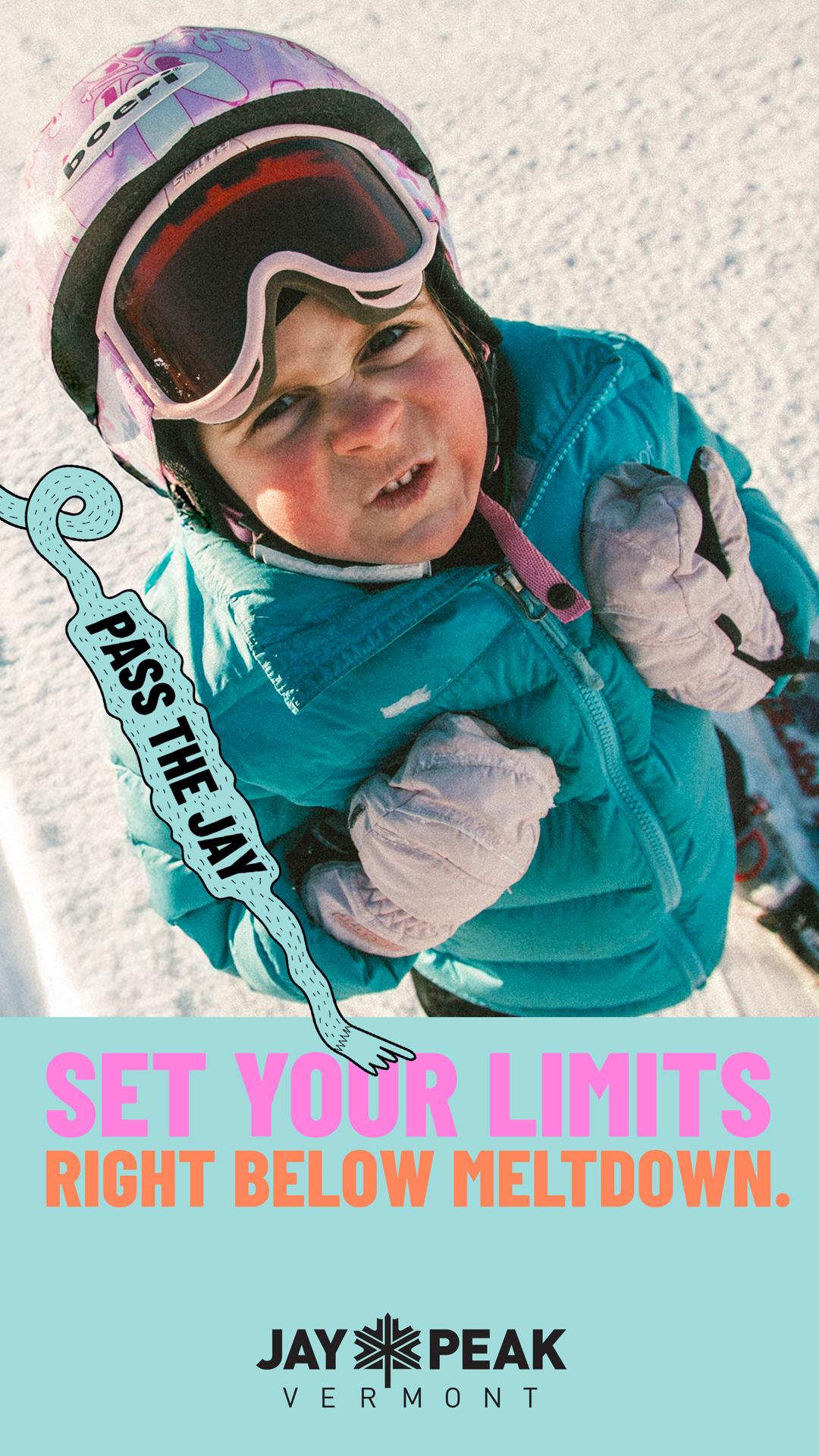 Child in winter gear squinting in sunlight on snowy ground, holding ski poles.