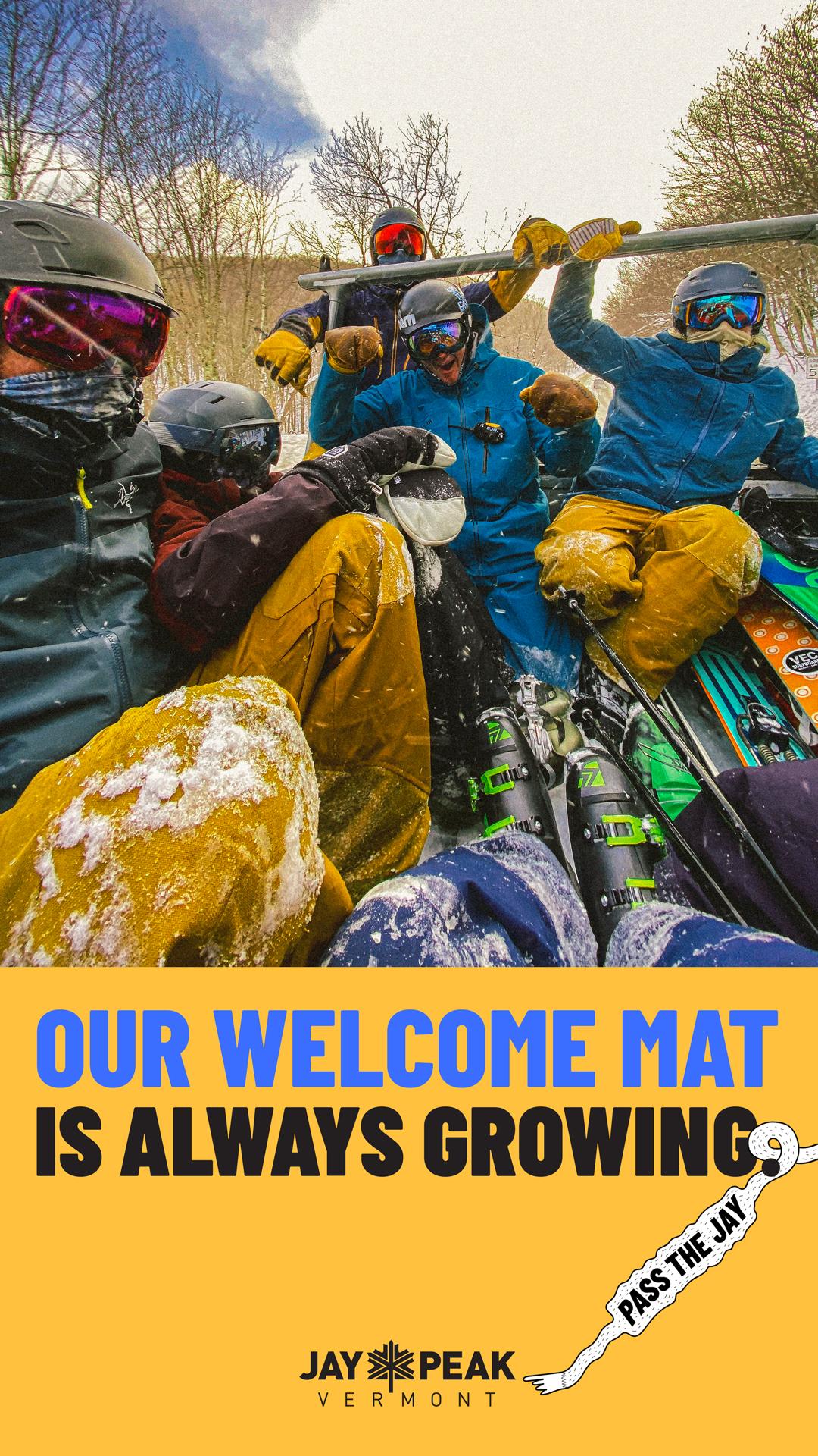 Group of skiers on a snowy ski lift, wearing vibrant winter gear.