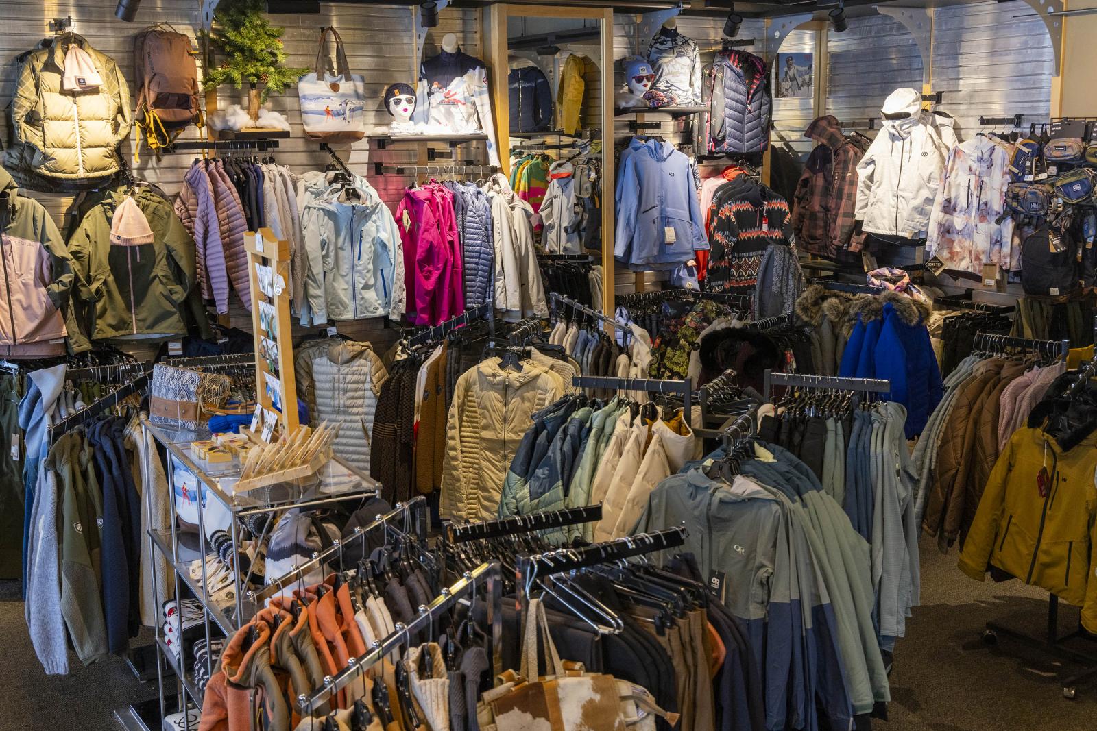 Clothing store interior featuring various jackets and shirts on racks.