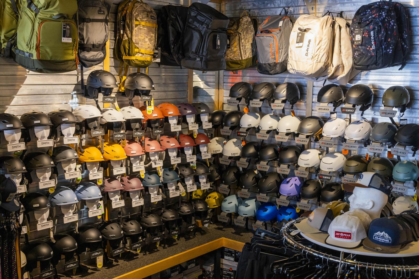 Helmets and backpacks displayed in a retail store.