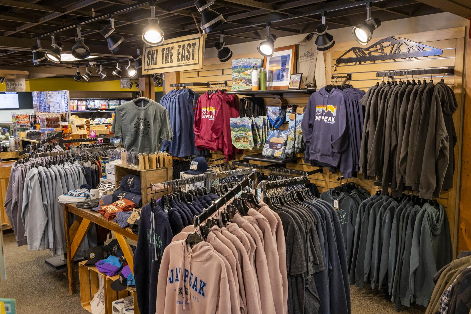 Clothing store interior with racks of sweatshirts and jackets.