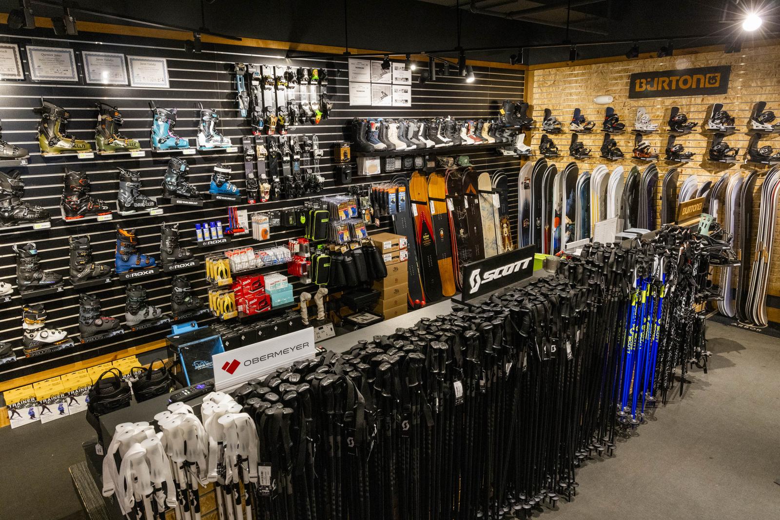 Ski shop interior with racks of skis, poles, and accessories.