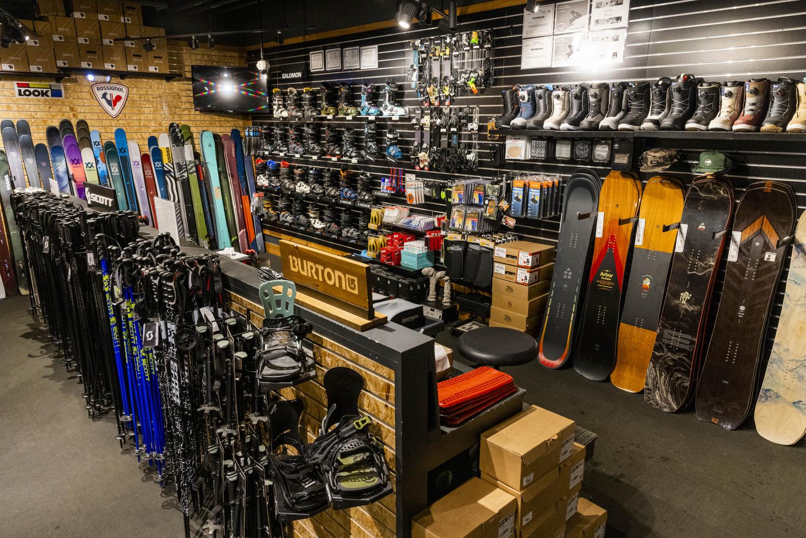 Snowboard shop with gear, boards, and boots neatly displayed.