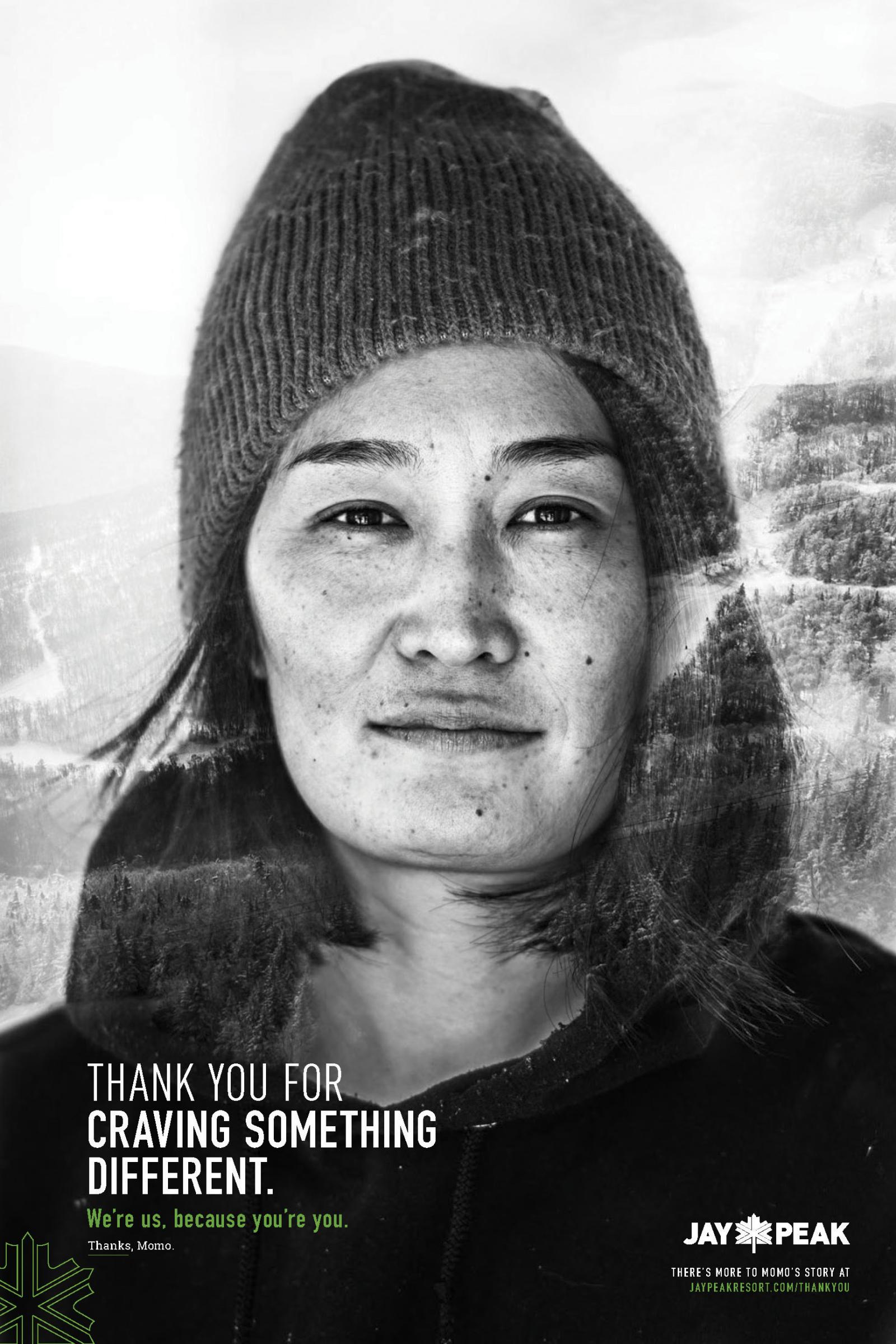 Person wearing a beanie in a snowy setting, black and white photograph.