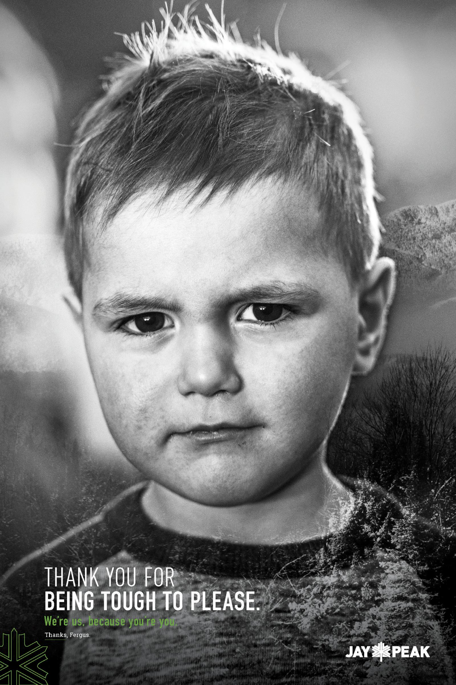 Young boy with a serious expression, in black and white photograph.