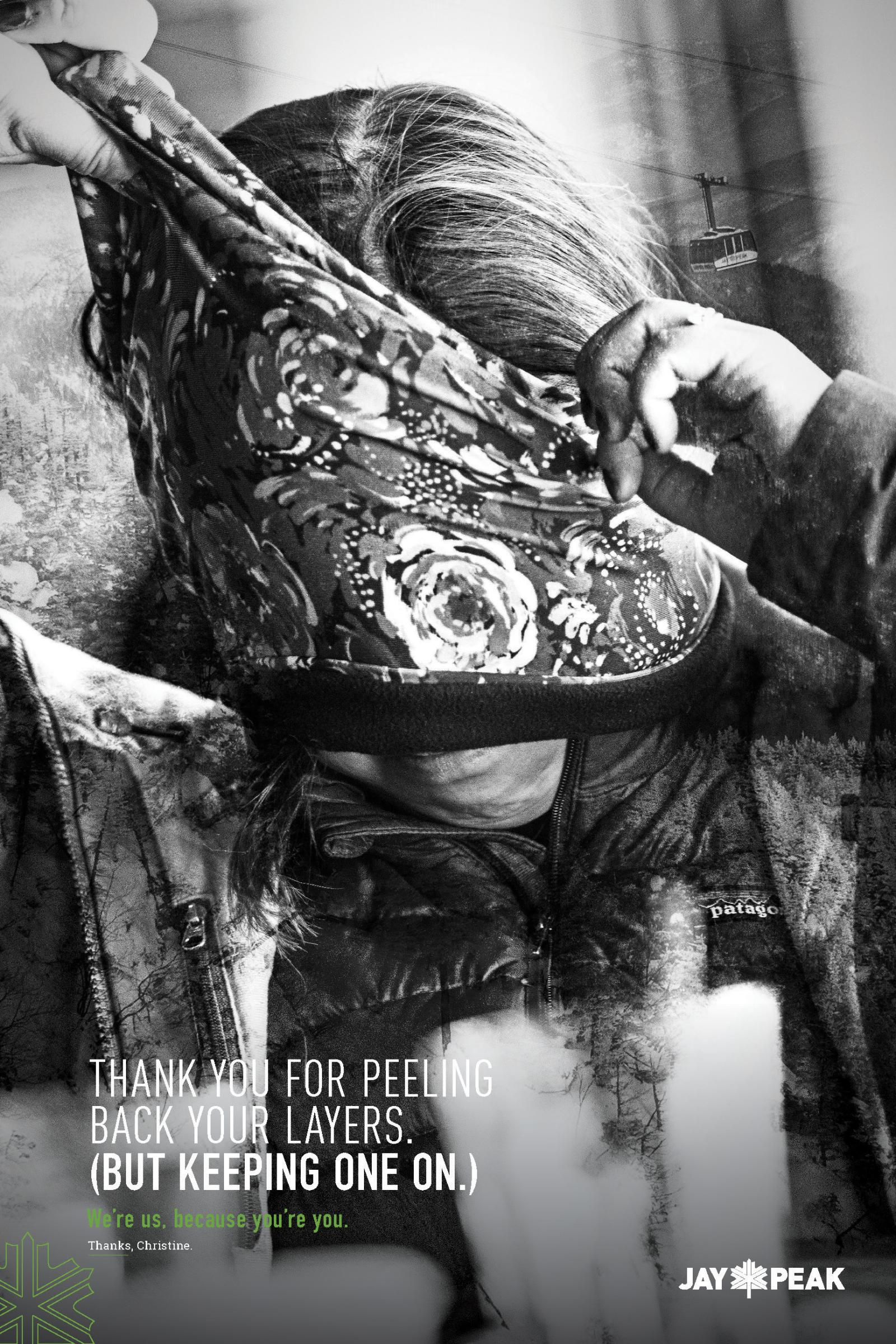 Black and white photo of a person lifting a patterned scarf over their head.