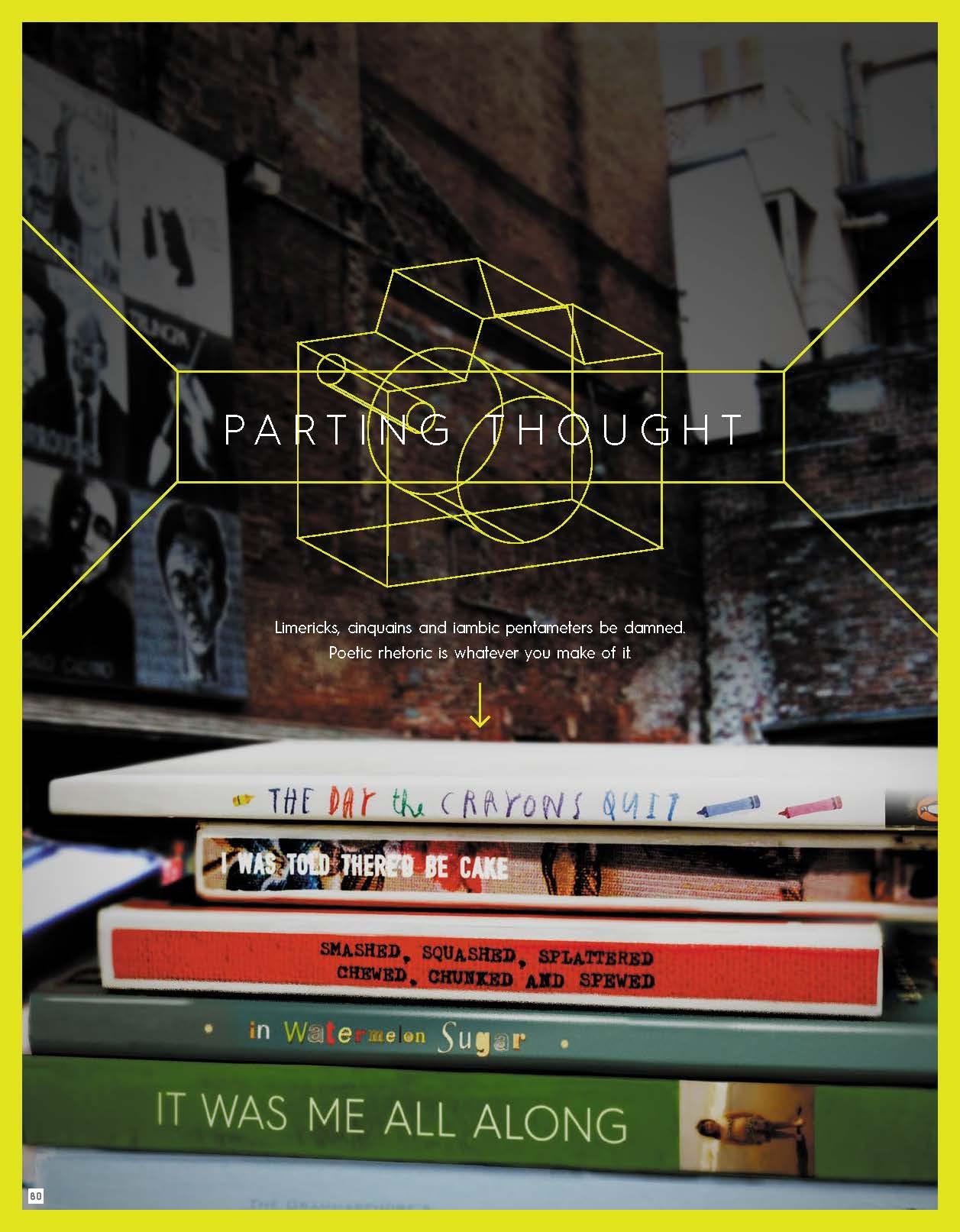 Books stacked in front of a brick wall with yellow geometric lines.