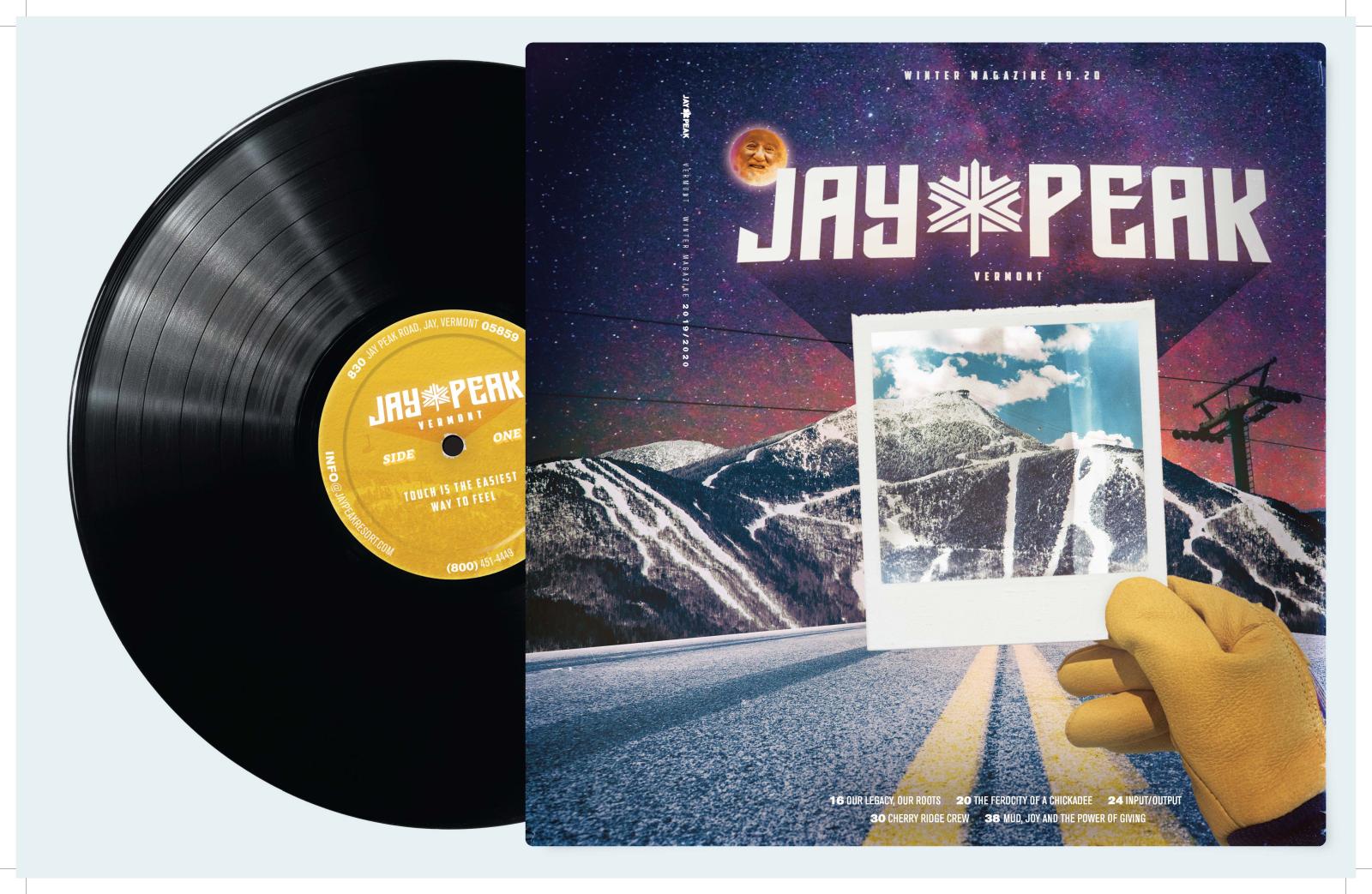 Vinyl record beside a colorful mountainous album cover.