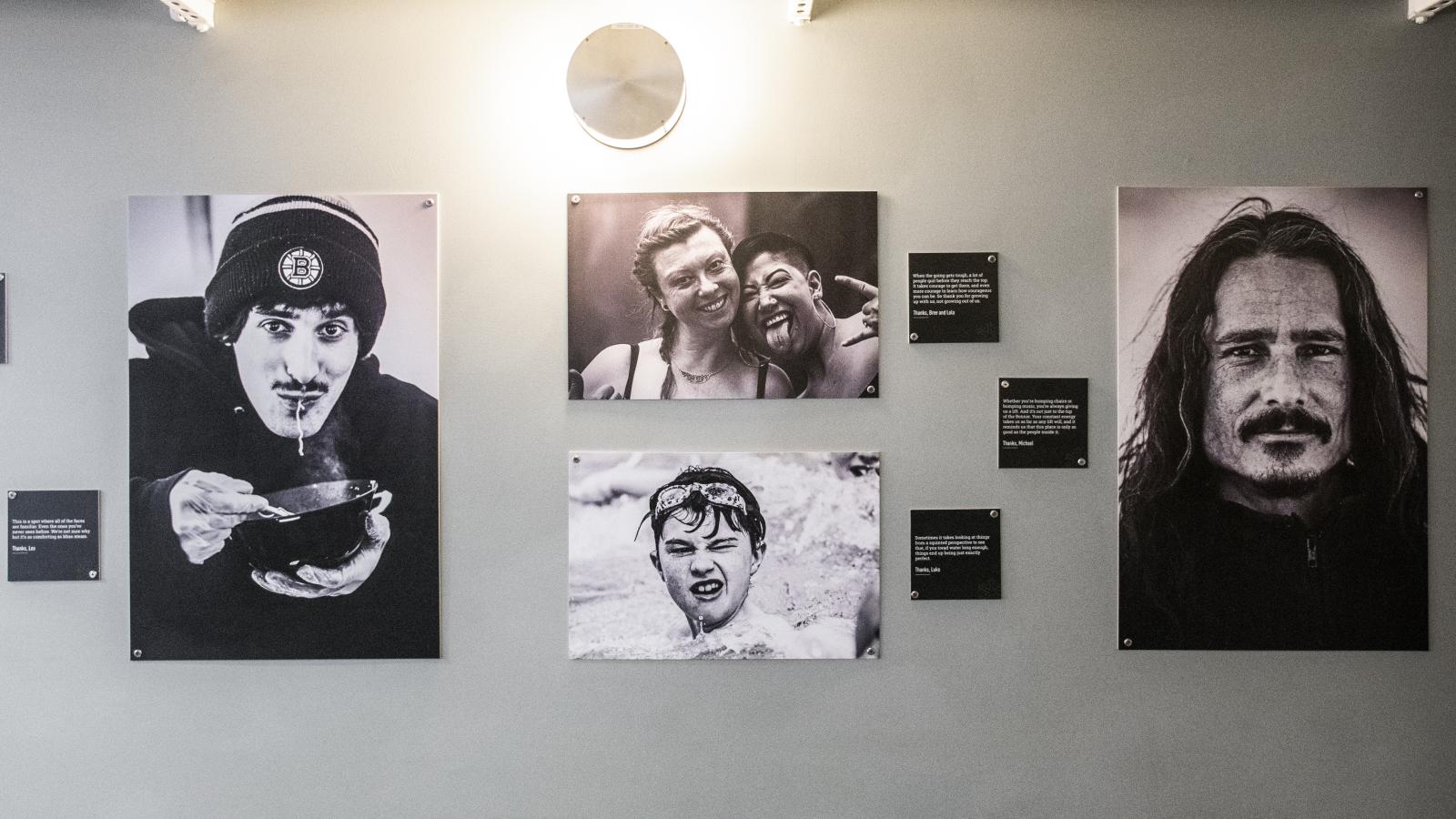 Black and white portraits of diverse expressions on an art gallery wall.