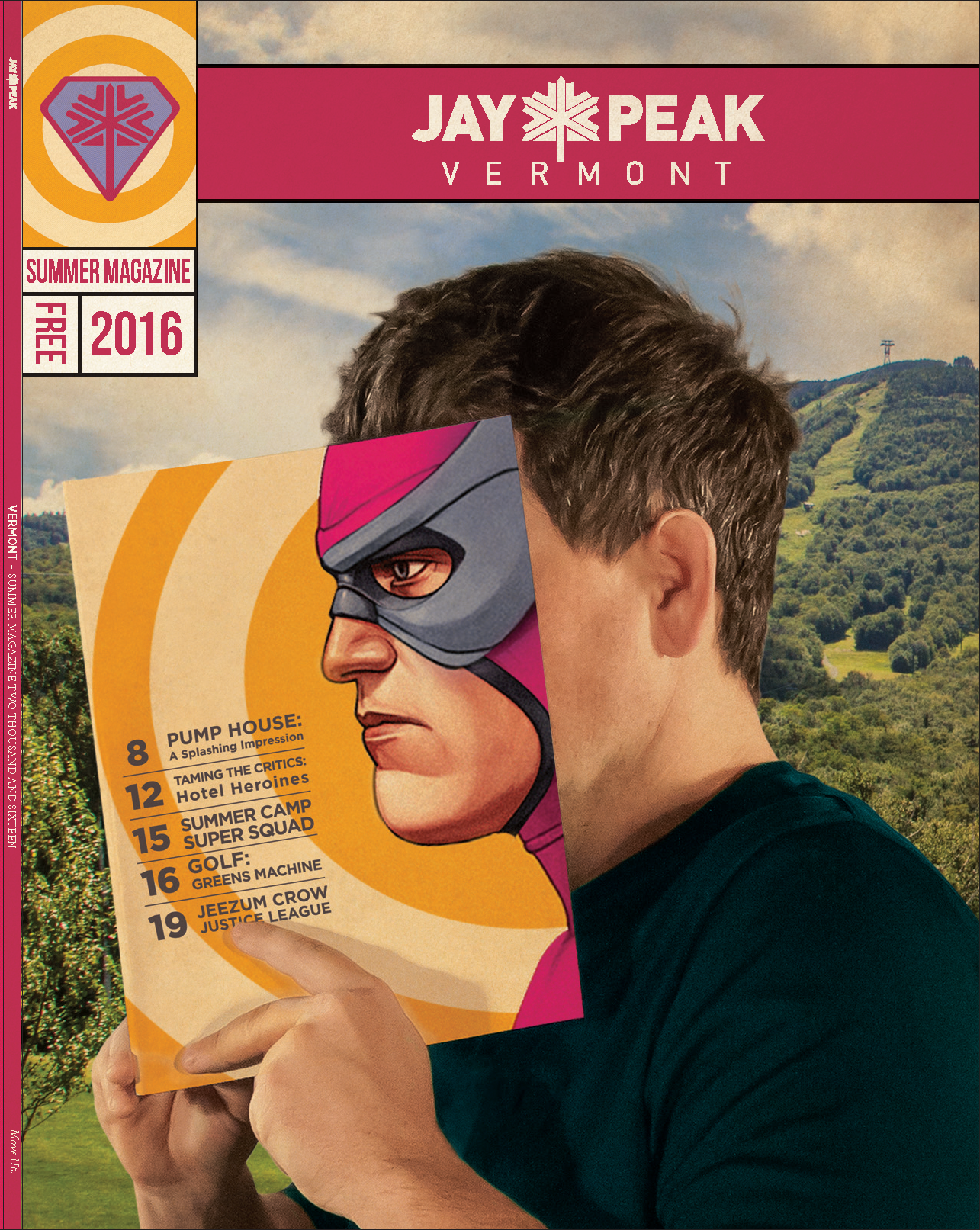 Man holding a comic-themed magazine against a mountain backdrop.