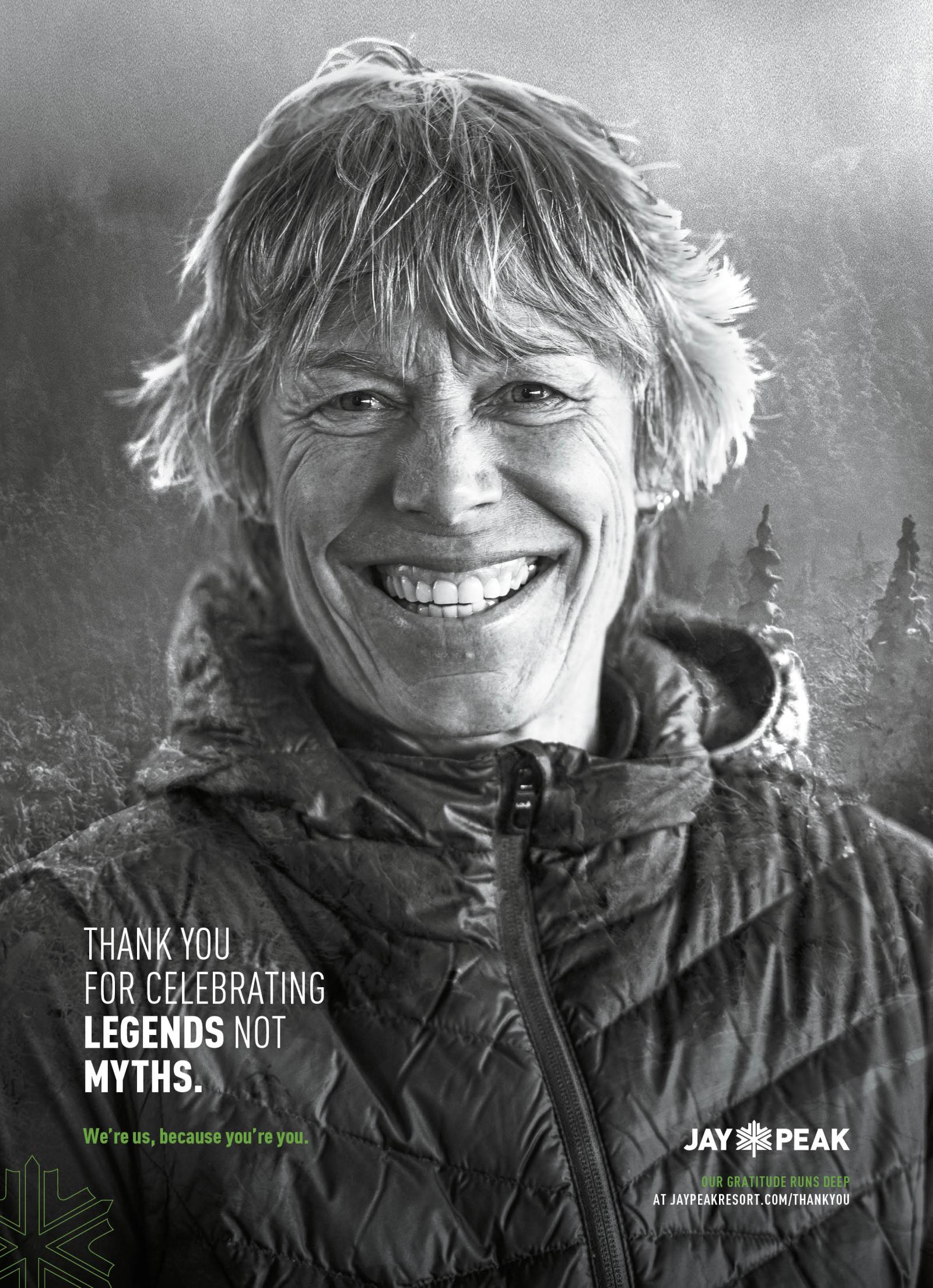 Smiling person in a winter jacket, grayscale photo.