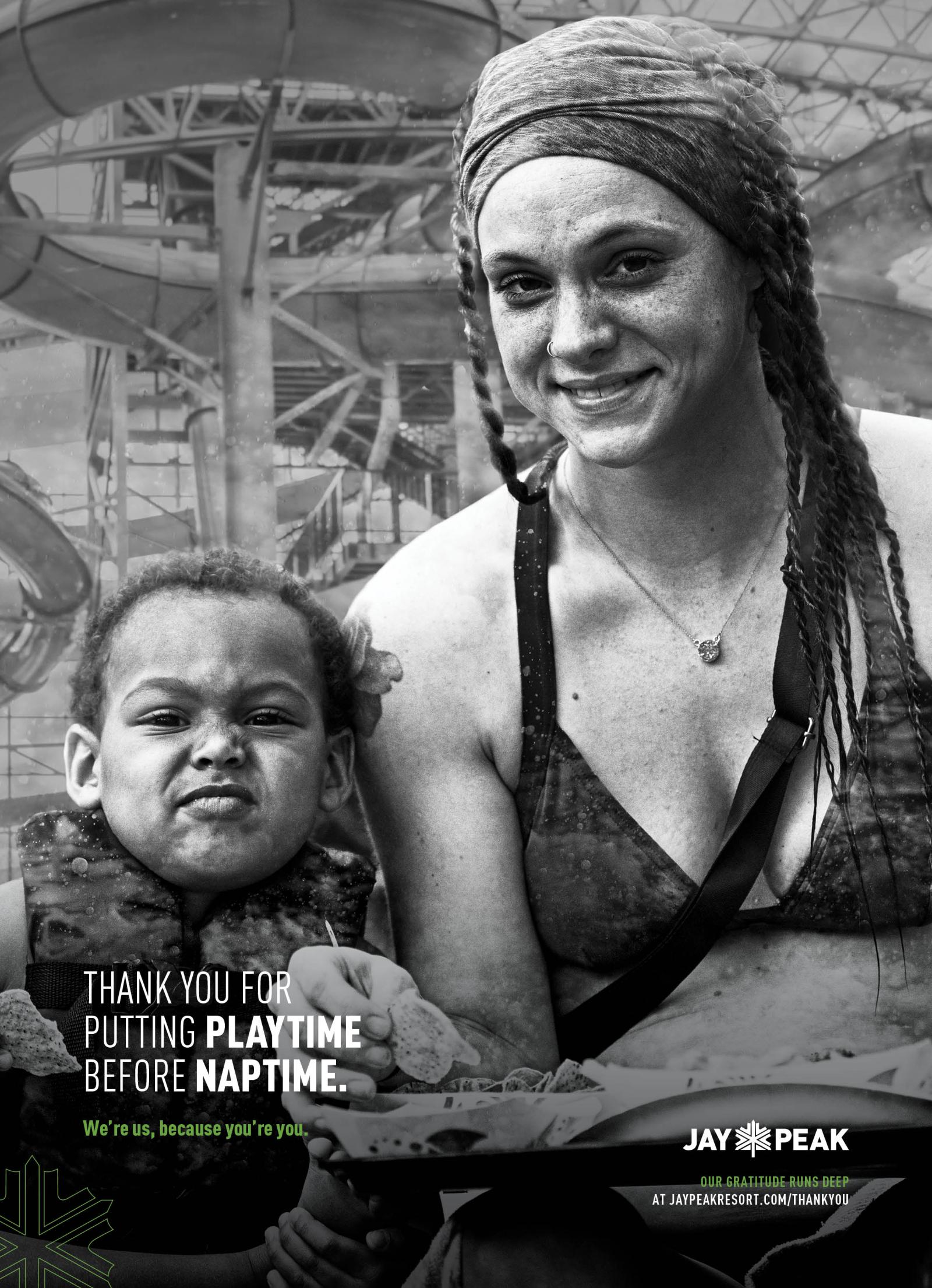Mother and child wet in swimsuits, smiling, with a water park background. Black and white photo.