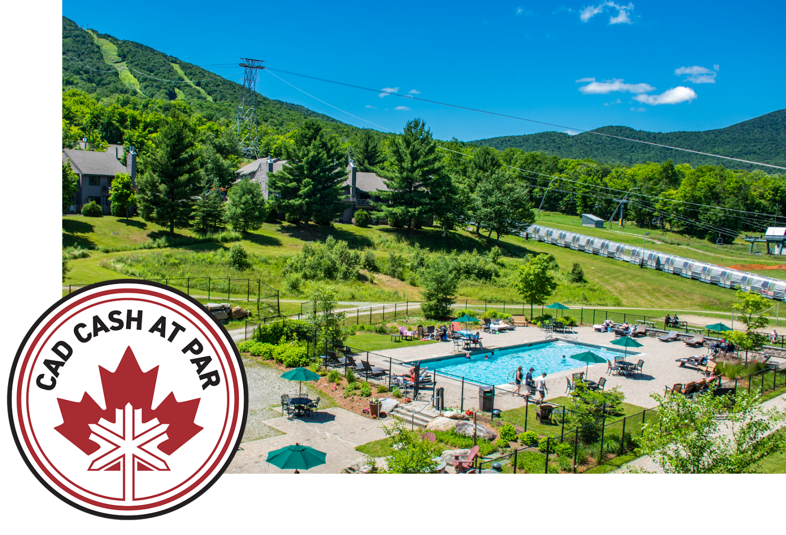 Pool area with sun umbrellas, surrounded by green hills under a clear blue sky.