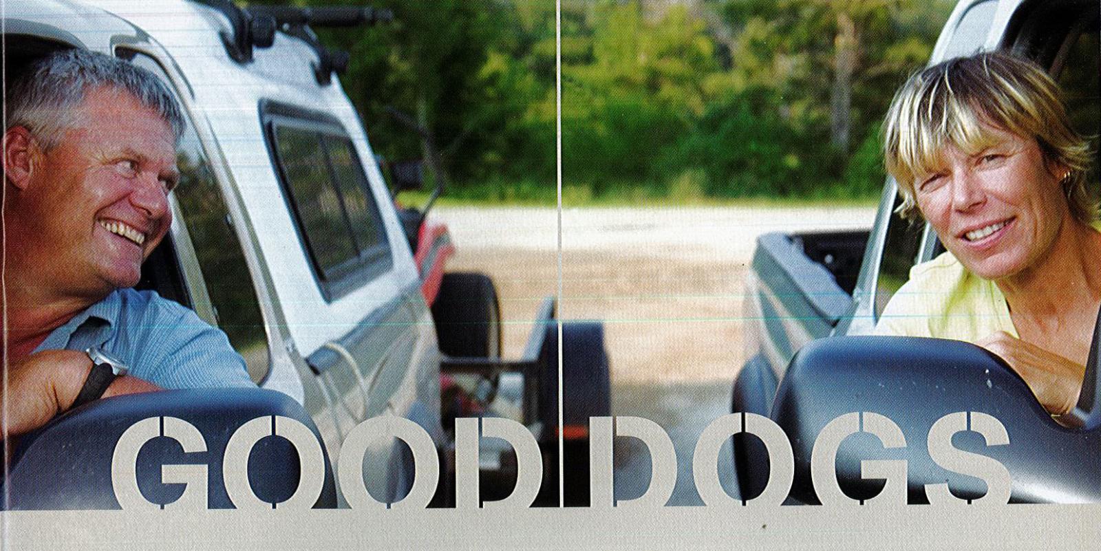 Two people smiling from car windows, trees in background.