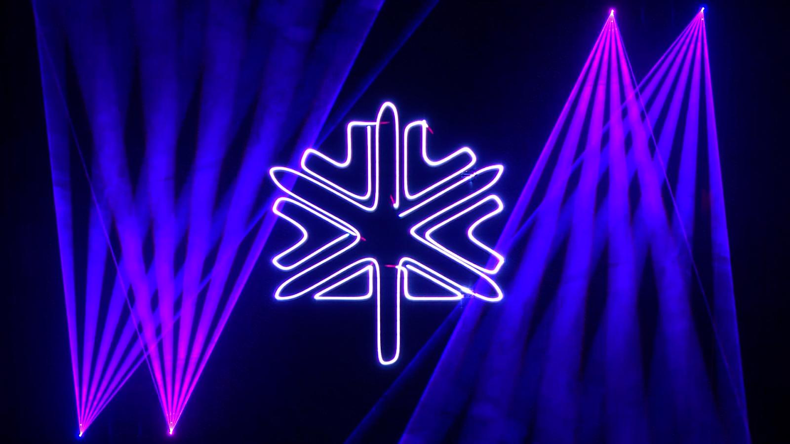 Neon purple snowflake and beams on a dark background.