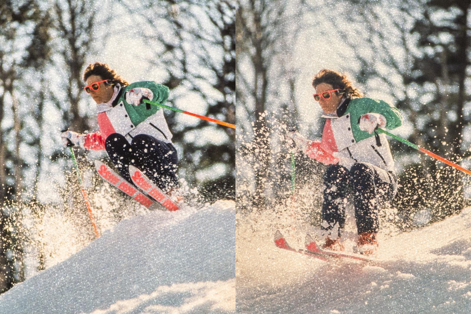 Skier in colorful gear descends a snowy slope amid trees.
