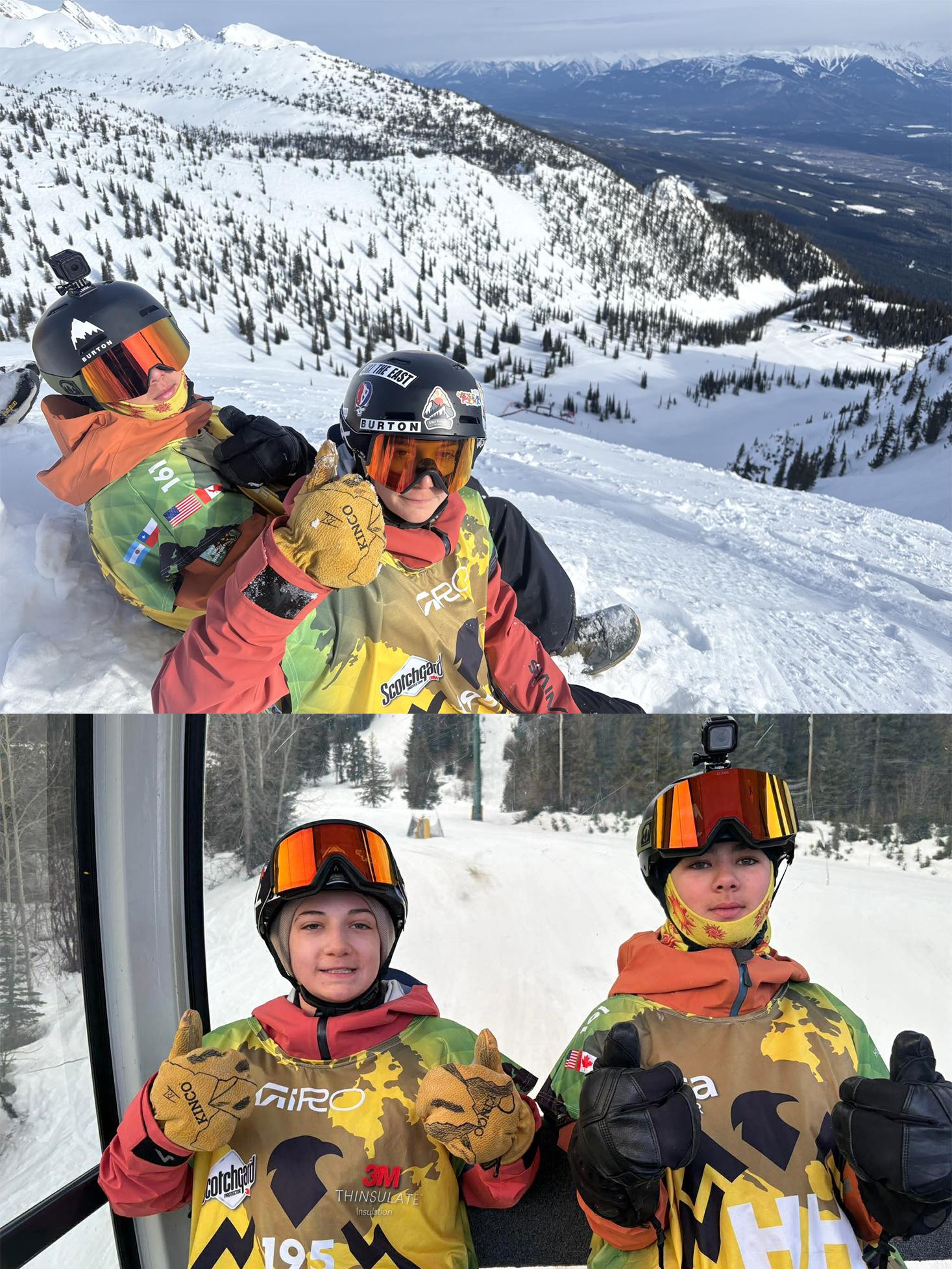 Two kids in snow gear, sitting on a snowy slope, wearing helmets and goggles, with mountains in the background.