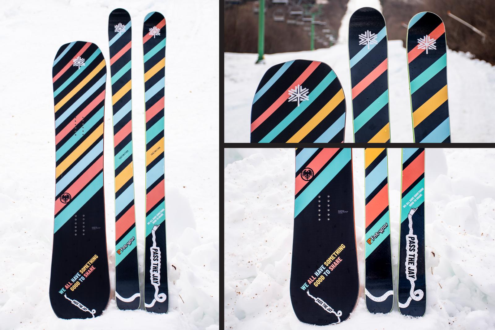 Colorful striped snowboards and skis on snow.