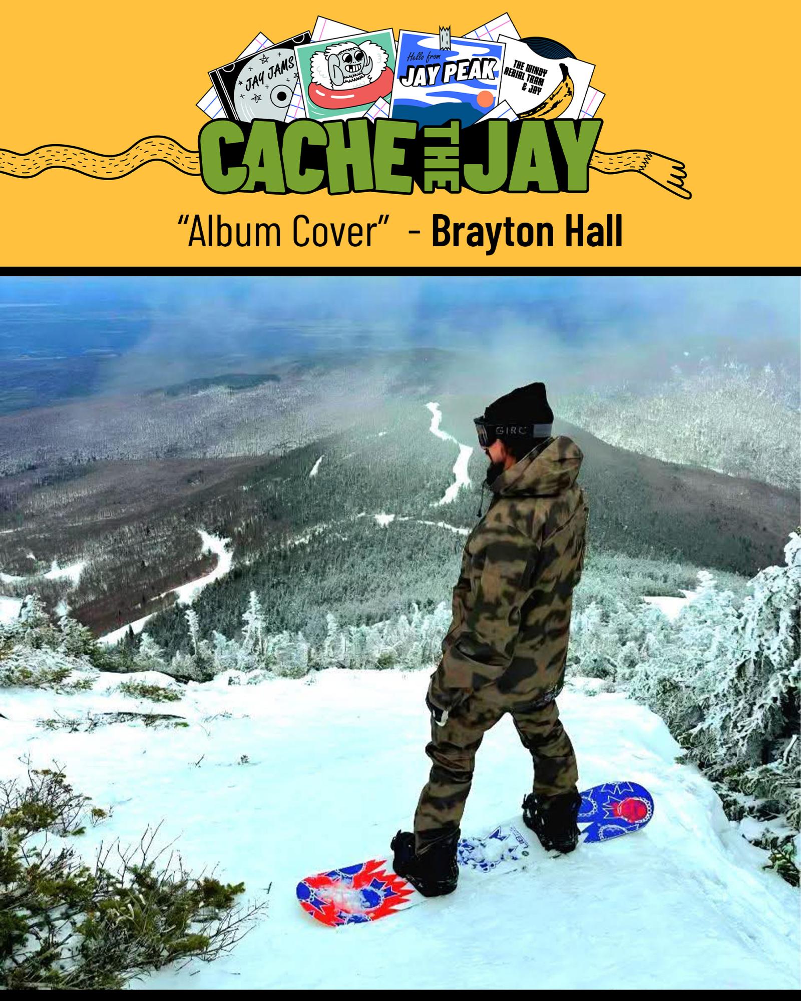 Snowboarder in camo gear looks out over snowy mountain landscape.