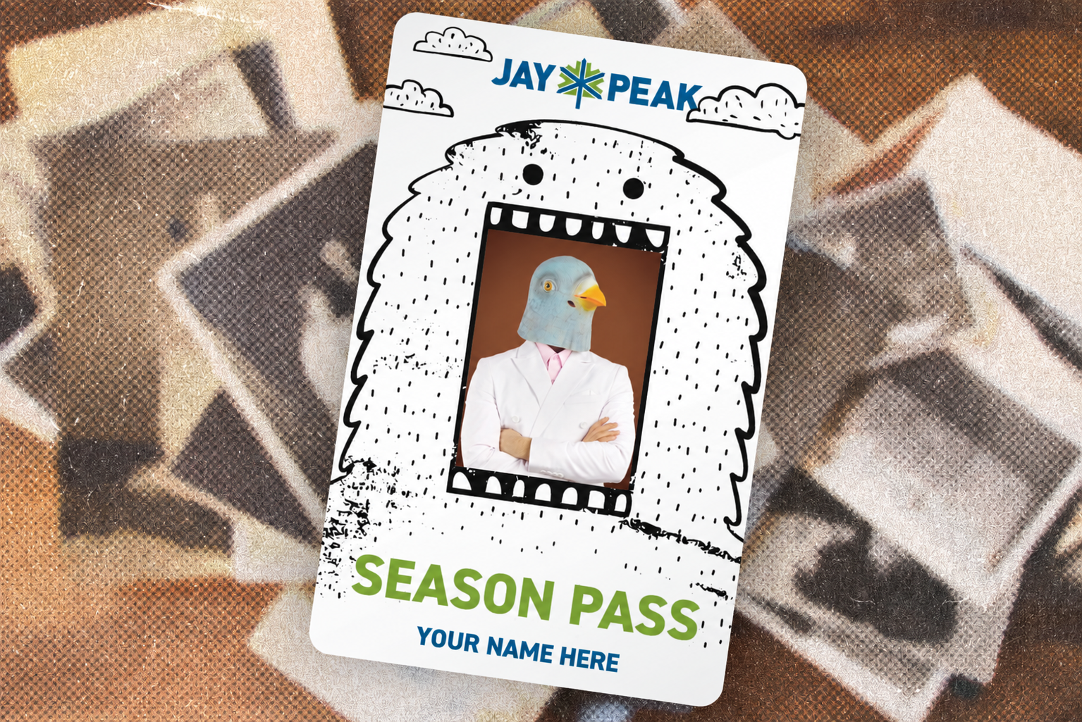 Cartoon yeti outlines a pigeon in a suit on a Jay Peak season pass.